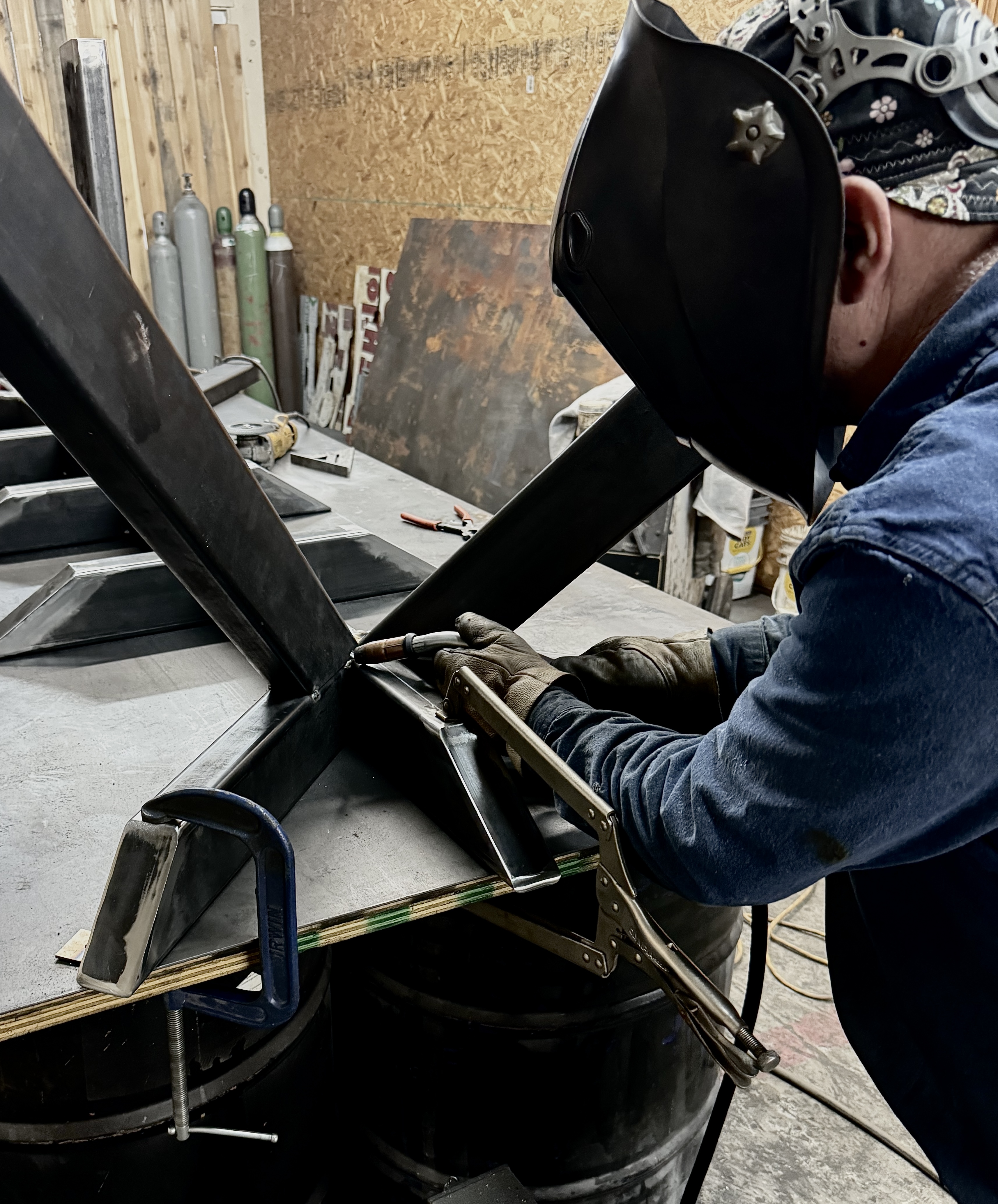 Fabricated metal components staged on a Gainesville TX shop table