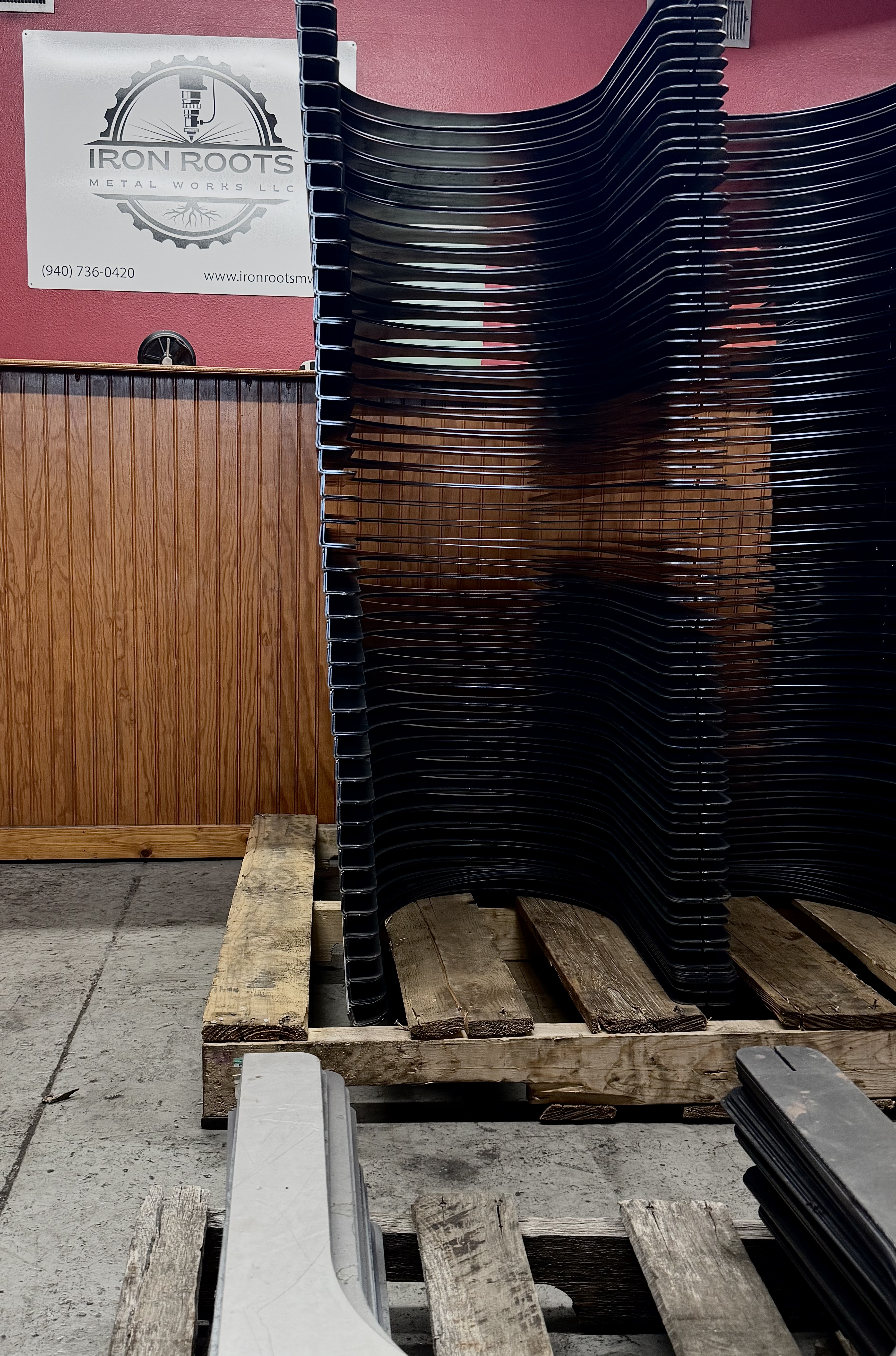 Precision cut metal parts staged before finishing at Iron Roots Metal Works